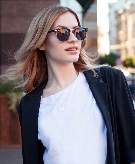 Woman with sunglasses walking outdoors