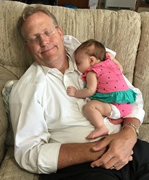 Doctor Noorda and his baby granddaughter sleeping on couch