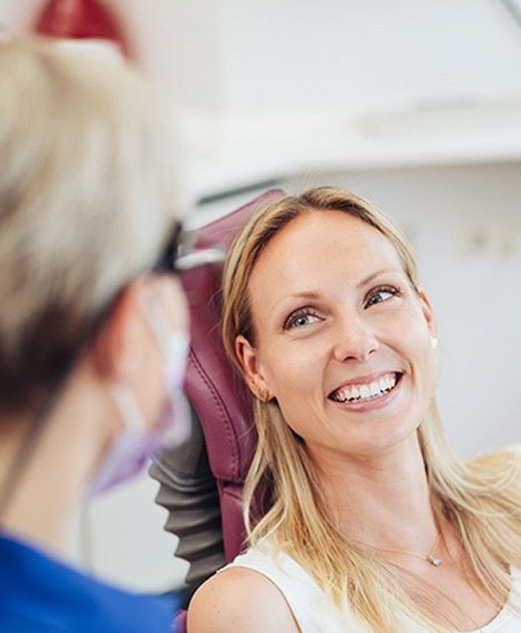 Woman visiting her dentist to prevent dental emergencies in Henderson