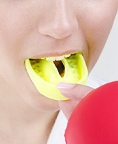 Person wearing a yellow mouthguard