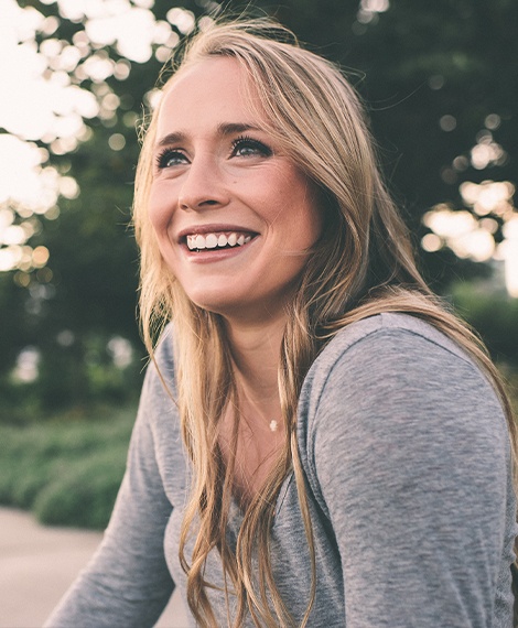 Blonde woman smiling outdoors