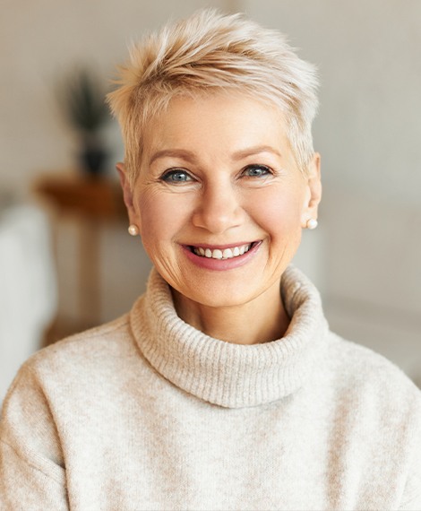 Woman in white sweater smiling