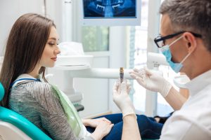 Dentist talk to patient about dnetal implants