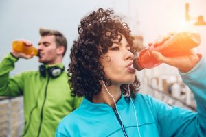 a couple consuming sports drinks