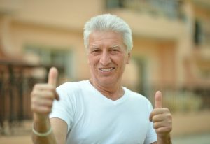 man smiling happy with new dental implants