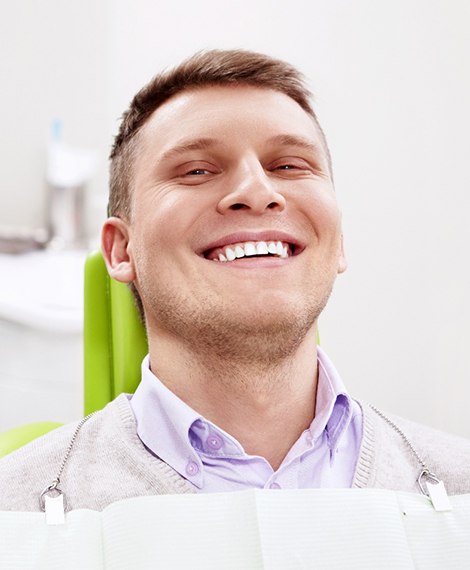 Male dental patient smiling after getting dental implants in Henderson