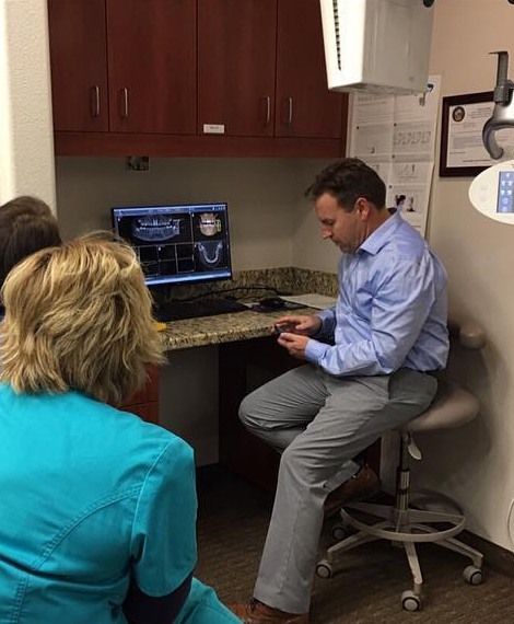 Dentist and patient reviewing digital x-rays