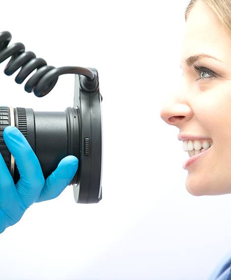 Dentist using high tech camera to capture digital pictures