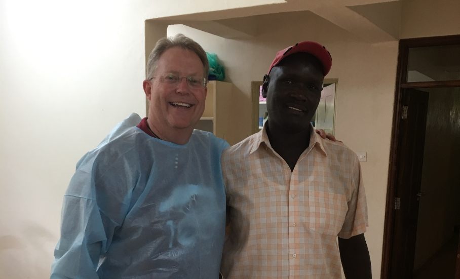 Doctor Noorda smiling with young man in dental office