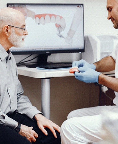 Man listening to his dentist talk about All On 4 implant dentures