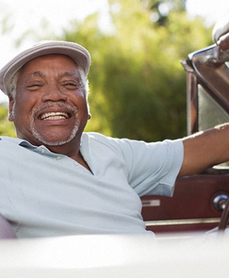 Man driving car and smiling