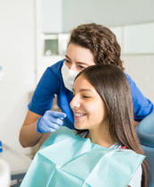 Teenage girl with braces smiling at the dental office