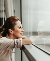 Woman looking out of window