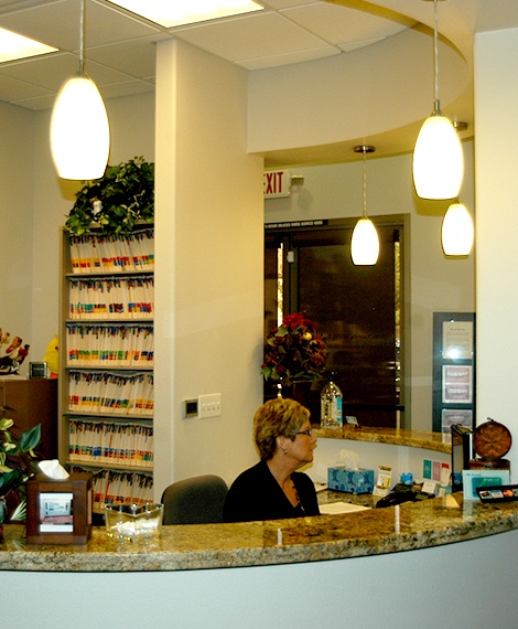 Dental team member behind the reception desk