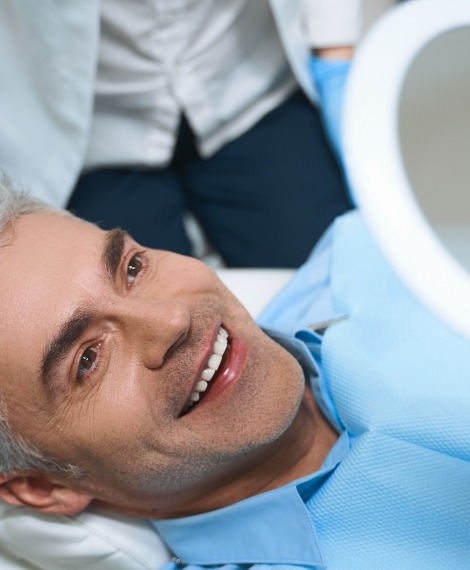 Man sharing healthy smile after dental implant tooth replacement