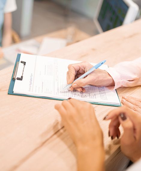 Patient filling out dental insurance forms