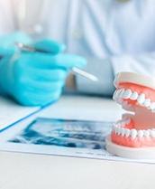 a set of plastic teeth in front of a dentist