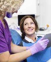 Dentist showing a tablet to a patient