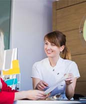 Dental team member showing paperwork to a patient