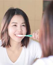 Young woman brushing her teeth