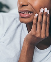 Person with toothache holding cheek