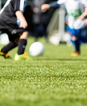 Teens playing soccer before knocking out a tooth