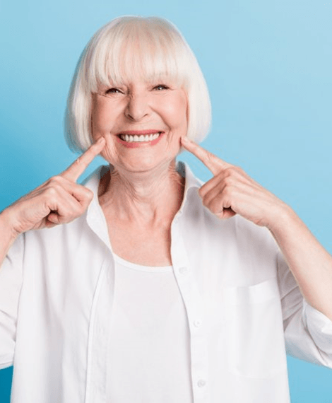 A woman pointing at her smile