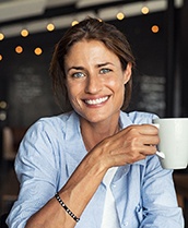 woman holding a white coffee mug