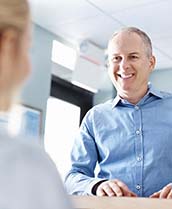 Man submitting dental insurance forms to his dental team