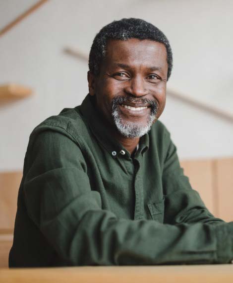 Smiling senior man sitting at a table