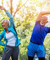 Senior couple wearing exercise clothes and stretching