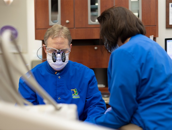 Dentist treating patient under dental sedation