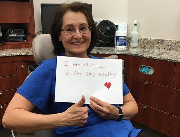 Friendly dental team member giving a thumbs up