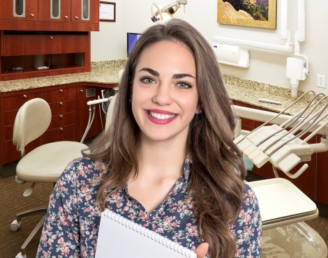 Woman in floral blouse smiling in dental office
