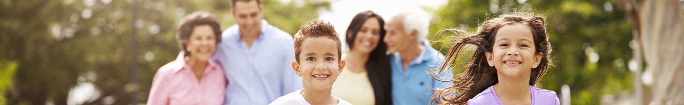 Family of six grinning outdoors after visiting dentist near Green Valley South