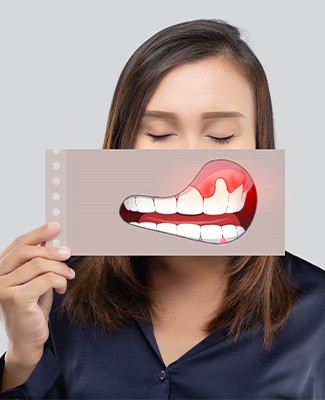 Woman closing eyes holding image of gum disease in front of her face