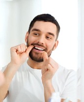 Man flossing his teeth