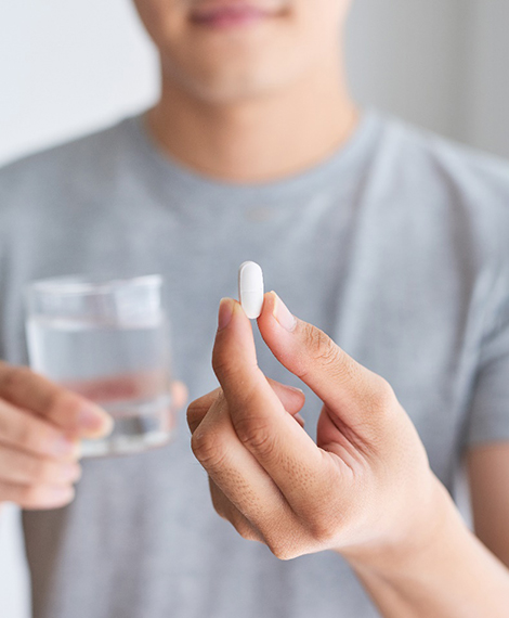 closeup of person holding sedation pill