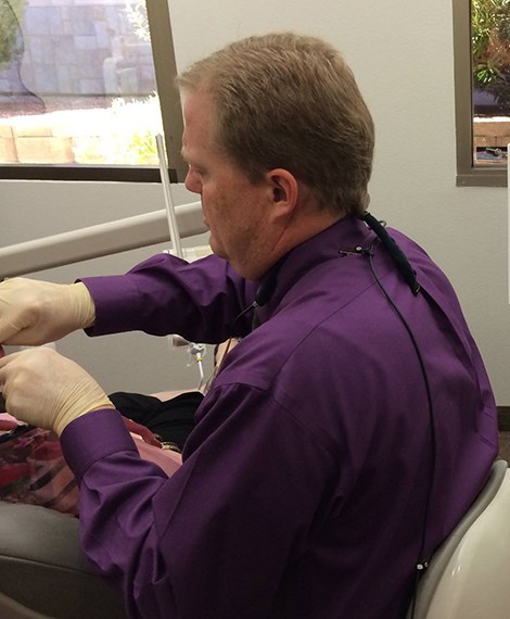 Dentist treating patient under sedation dentistry