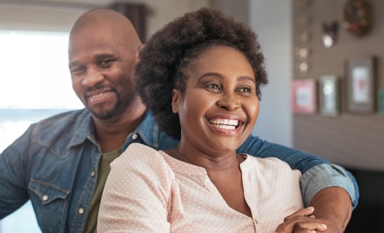 Man and woman smiling indoors