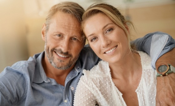 Smiling man and woman holding each other