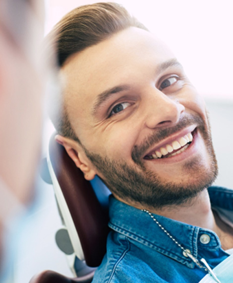 Man smiling at dentist in treatment chair