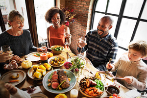 Family around table enjoying Thanksgiving meal