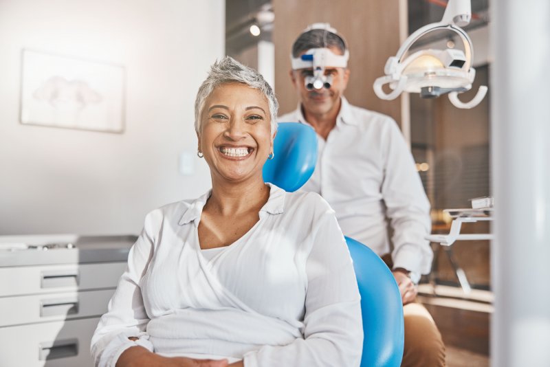 a patient smiling after getting full arch replacements