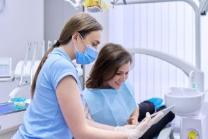 Patient and dental team member looking at tablet