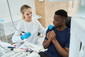 Patient looking nervous as he talks to his dentist